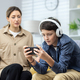 Family conflict quarrel, woman mother quarrels with son, teenage boy in headphones ignores woman - PhotoDune Item for Sale