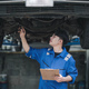 Vehicle service maintenance asian man checking under car condition in garage. Automotive mechanic - PhotoDune Item for Sale
