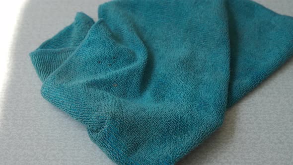 Dirty Microfiber Cloth is Lying on Table After Cleaning