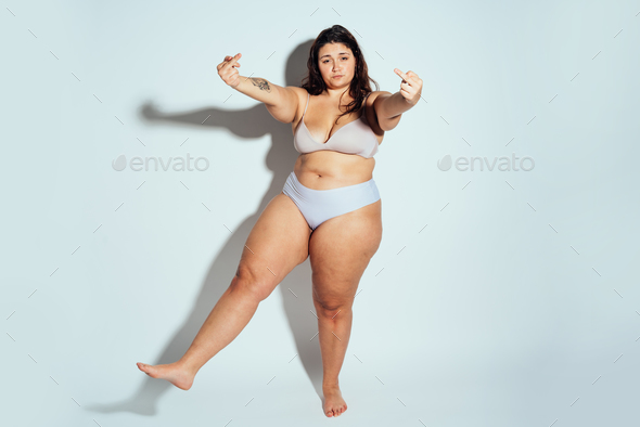Plus size woman posing in studio in lingerie - Stock Photo - Images