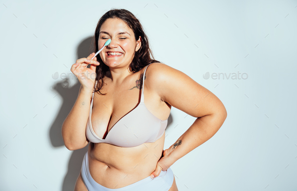 Plus size woman posing in studio in lingerie - Stock Photo - Images