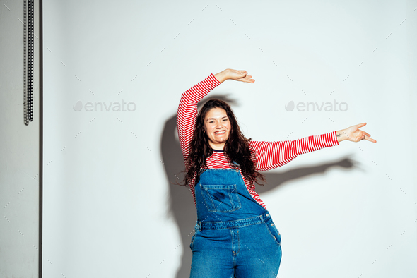 Plus size woman posing for body acceptance Stock Photo by oneinchpunchphotos