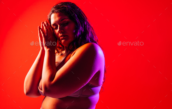 Plus size woman posing in studio in lingerie. - Stock Photo - Images