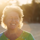 Happy senior woman on beach in tropical destination at sunset - PhotoDune Item for Sale