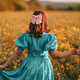 Unrecognizable woman in yellow canola flowers field.Lady in retro dress. Harvest - PhotoDune Item for Sale