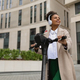 adult african american woman in headphones with a smile on an electric scooter on the background of - PhotoDune Item for Sale