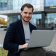young charismatic successful businessman working on laptop outside - PhotoDune Item for Sale