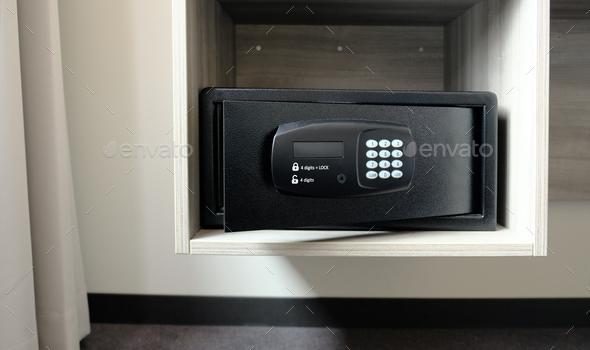 Metal safe box in the closet. Small narrow safe for keeping money or valuables in the hotel.