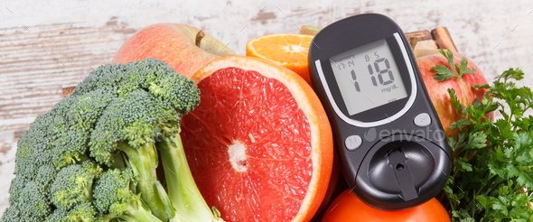 Glucose meter with healthy fruits and vegetables. Checking sugar level, diabetes