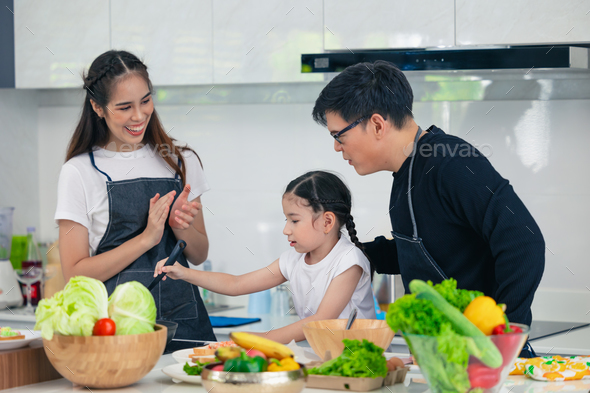 Asian family is cooking in the kitchen together