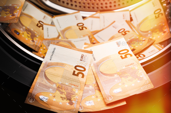 Money laundering symbol, 50 euro banknotes inside washing machine. Tax evasion. Illegal fi