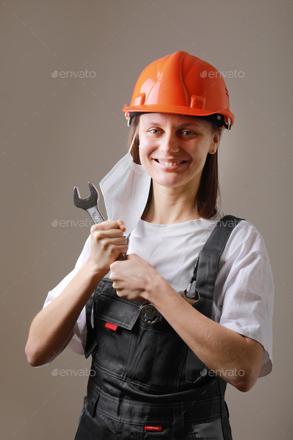Professional Industrial smiling female worker holding a wrench for adjust and tune up the mechanic
