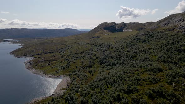 Beautiful aerial shot flying over a lake in the mountains of Rogaland, Norway alt