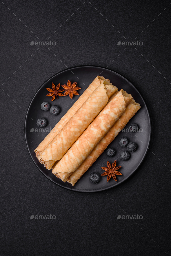 Delicious crispy wafer rolls with cream filling with nuts Stock Photo