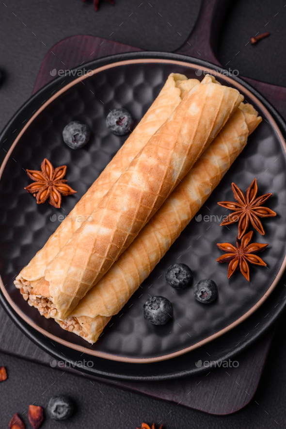 Delicious crispy wafer rolls with cream filling with nuts Stock Photo