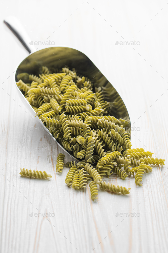 Mung bean fusilli pasta on a wooden background. Stock Photo by Olena_Rudo