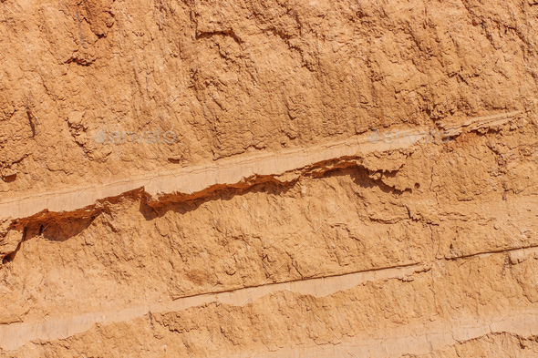 Background of great clay wall or brown ocher Grunge rock texture Cracked ground texture Canyon rock.
