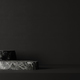 Dark stone podium on black background wall.  - PhotoDune Item for Sale