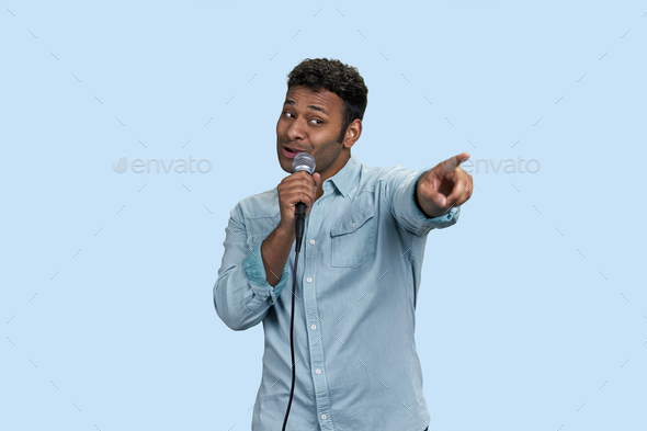 Portrait of an indian singer pointing at someone from audience.