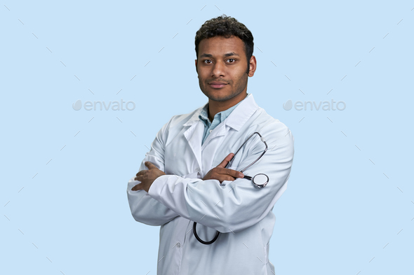 Smiling male indian doctor wearing medical coat and stethoscope. - Stock Photo - Images
