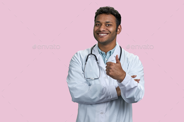 Portrait of indian male doctor with stethoscope in showing thumb up. - Stock Photo - Images