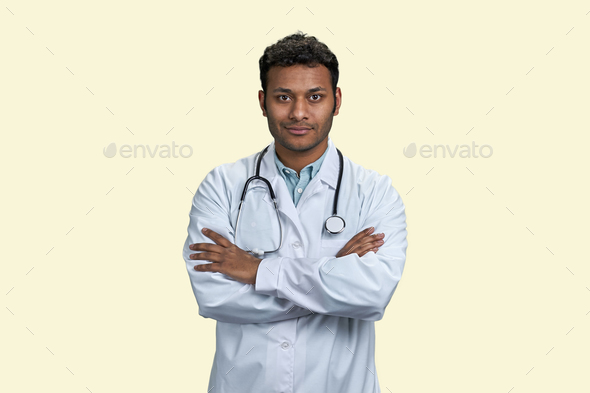 Portrait of male indian doctor with folded arms. - Stock Photo - Images