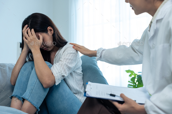Asian psychology doctor examine and listen to woman patient at home.