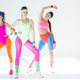 beautiful sporty girls in 80s style sportswear exercising together