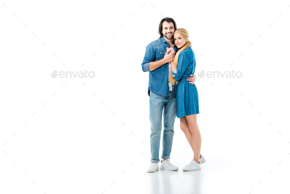 Girl in denim dress and man in jeans and denim shirt hugging each other ...