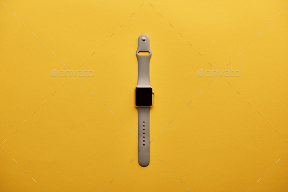 top view of smart watch with blank screen on yellow surface Stock Photo 