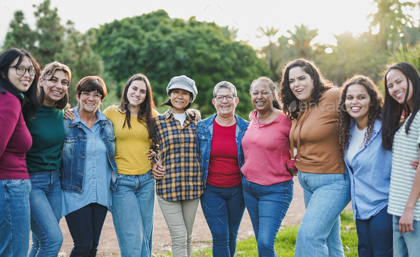 Group of multi generational women hugging each other while smiling on ...