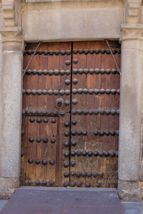 Old rustic vintage wood door closeup background. Ornamental gate detail