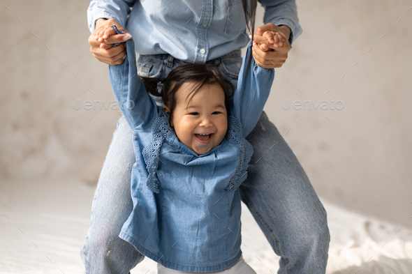 Cheerful Korean Little Baby Girl Walking Holding Mom\'s Hands Indoor