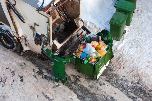 garbage collection workers pick up household waste in winter