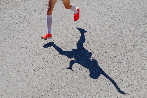 legs female runner in compression socks run race, positive silhouette woman athlete jogger in road