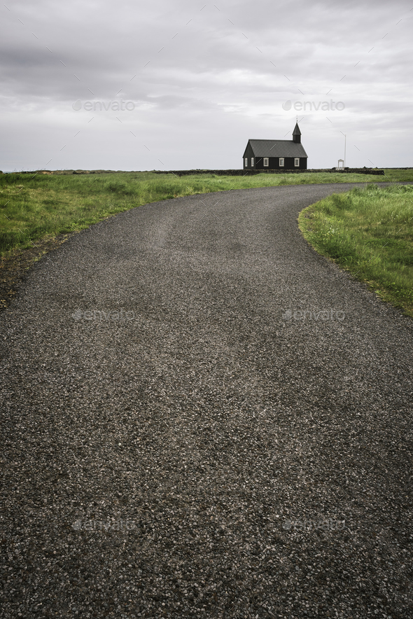 Road leading to Black wooden church Budakirkja in Iceland