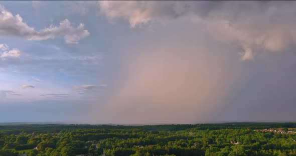 Bright Rainbow in the Sky During a Severe Thunderstorm Against Landscape alt