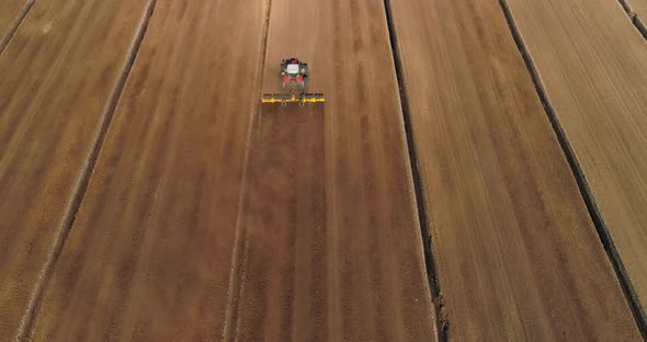 Peat Harvesting Plowing Tractor Extracting Turf in Drained Bog Aerial View alt