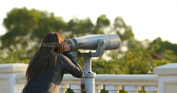 Woman tourist looking though the binocular at outdoor Stock Photo by ...