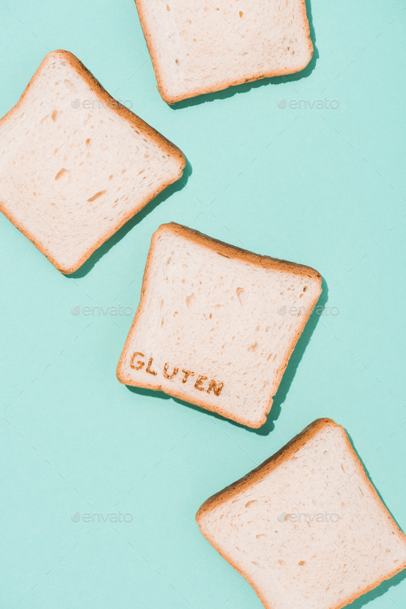 top view of messy spilled bread slices with burned gluten sign on blue