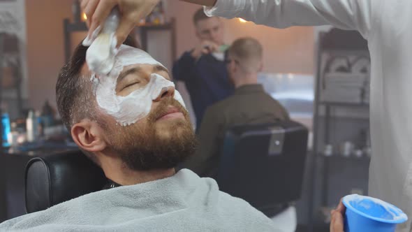 Customer at Barber Shop with Shaving Cream Before Beard Shaving alt