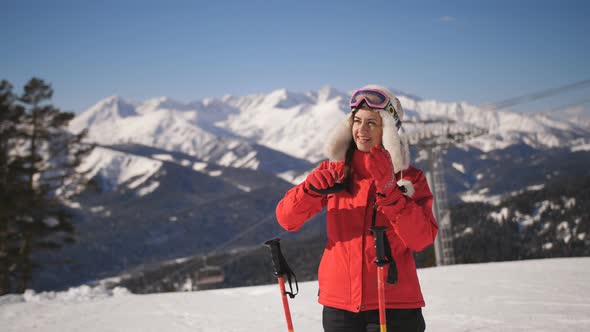 Closeup Portrait of Female Skier on Mountain Ski Resort