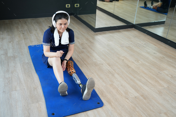 Stay active, Young woman with bionic leg exercise in fitness. healthy and sport concept.