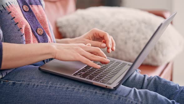 Unrecognizable Woman Using Computer at Home