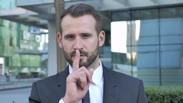 Silence Please Finger on Lips By Beard Businessman alt