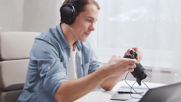 Workplace of freelance worker at home office. Young man works using computer. alt