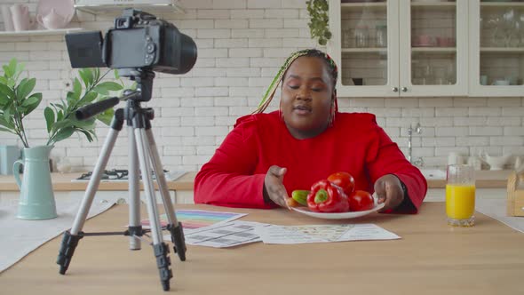 Black Female Food Blogger Recording Vlog in Kitchen alt
