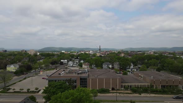 Flyover of La Crosse, Wisconsin, center, residential neighborhood, view toward river and mountains.