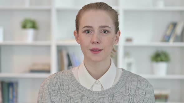 Portrait of Young Woman Saying Yes By Shaking Head alt