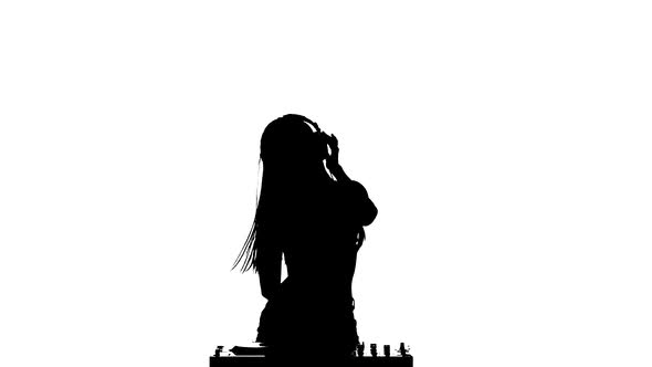 Girl DJ Sexy Dancing Erotically and Rotates His Head. Slow Motion. Silhouette alt